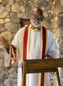 Mark Bozzuti-Jones in a white alb and red stole