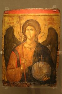 Painted icon of the Archangel Michael, holding a helmet and spear.