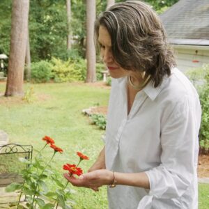 Rhonda Mawhood Lee among the flowers in her back garden.